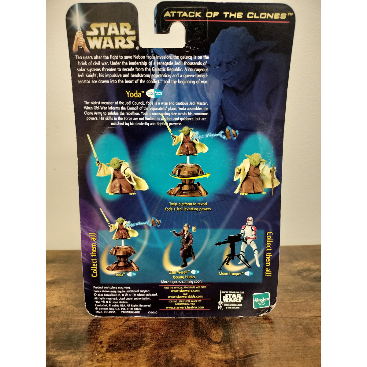 Actual item photographed: rear of Yoda Jedi Master 02/23 card showing Force Action instructions and packaging wear