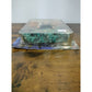Actual item: lower-angle close-up of Mudlap retail blister and bent lower card with edge wear